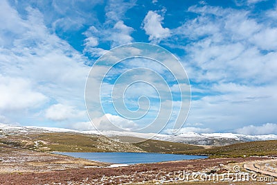 Horizontal view of a lake in the mountains in winter. Sunny day landscape and snowy mountains breathing pure and unpolluted air Stock Photo