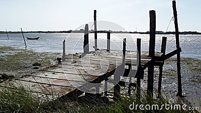 Wooden dock in low tide and bright sunny day Stock Photo