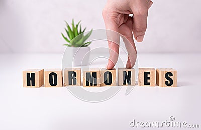 HORMONE word written on wood block, medical concept Stock Photo