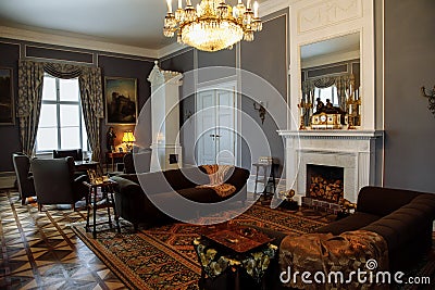 Horovice castle interior, Baroque chateau, carved wooden furniture in guest salon with sofa and armchairs, marble fireplace, Editorial Stock Photo