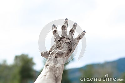 Horror and Halloween theme: Terrible zombie hands dirty with black nails reach for the sky, walking dead apocalypse, first-person Stock Photo