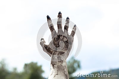 Horror and Halloween theme: Terrible zombie hands dirty with black nails reach for the sky, walking dead apocalypse, first-person Stock Photo