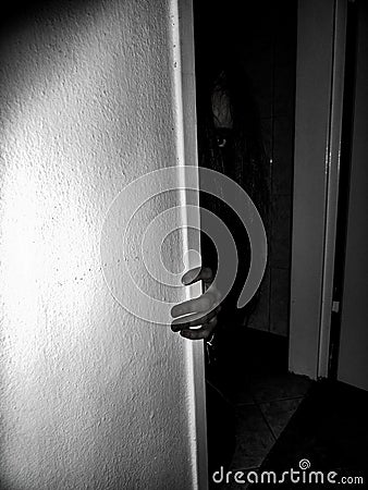 horror moment scary girl lurking outside the door Stock Photo