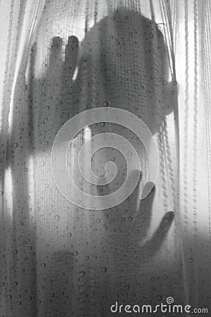 Horror person behind shower curtain in black and white Stock Photo