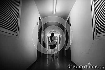 Horror photo of woman with long hair walking on corridor Stock Photo