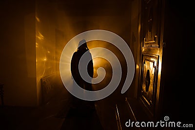 Horror silhouette of ghost inside dark room with mirror Scary halloween concept Silhouette of witch inside haunted house with fog Stock Photo