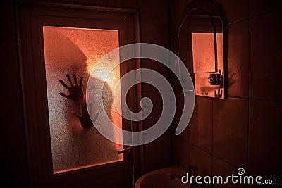 Horror silhouette of woman in window. Scary halloween concept Blurred silhouette of witch in bathroom. Selective focus Stock Photo