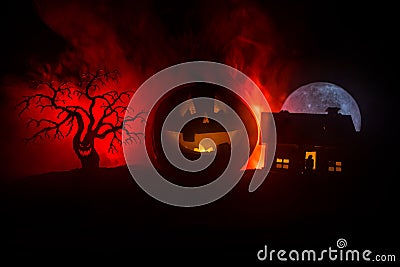 Horror view of Halloween pumpkin with scary smiling face. Head jack lantern with spooky building Stock Photo