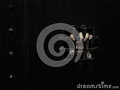 Horror woman locked in dark cage hand holding cage scary scene halloween concept Stock Photo