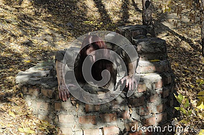 Horror woman well Stock Photo