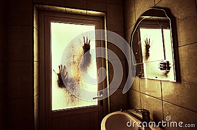 Horror woman in window wood hand hold cage scary scene halloween concept Blurred silhouette of witch Stock Photo