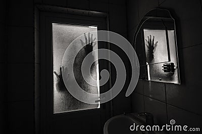 Horror woman in window wood hand hold cage scary scene halloween concept Blurred silhouette of witch Stock Photo