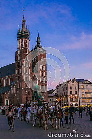 Horse with carriage in fronf of Basilica of Krakow at sunset in Poland Editorial Stock Photo