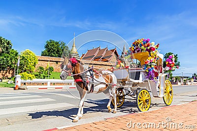 Horse carriage front of Wat Phrathat Lampang temple Stock Photo