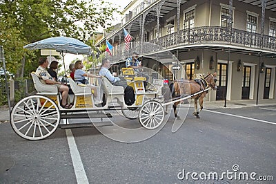 Horse Carriage and tourists in French Quarter of New Orleans, Louisiana Editorial Stock Photo