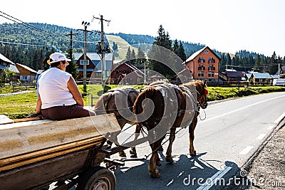 Horse carriage with wooden planks on mountain road in Bihor, Romania, 2021 Editorial Stock Photo