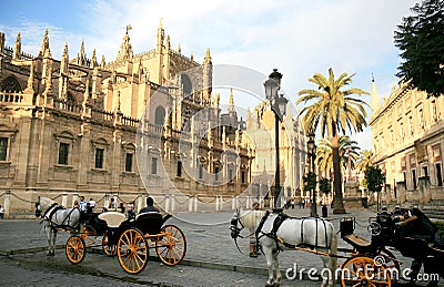 Horse-drawn carriages near cathedral, Seville Editorial Stock Photo