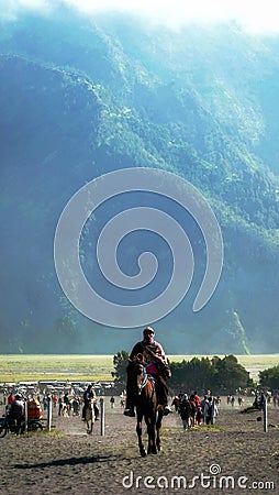 a horse guide who peddles his services at the foot of Mount Bromo in the morning of East Java Editorial Stock Photo