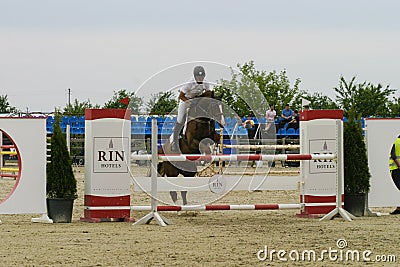 Equitation contest, horse jumping over obstacle Editorial Stock Photo