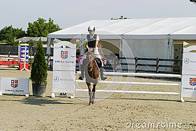 Equitation contest, horse jumping over obstacle Editorial Stock Photo