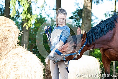 Horse kisses her owner- young lady`s hand. Stock Photo