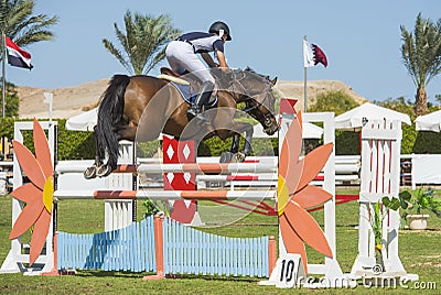 Horse and rider jumping in equestrian competition Editorial Stock Photo