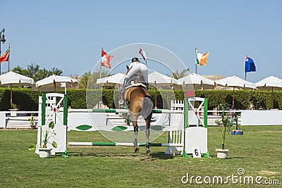 Horse and rider jumping in equestrian competition Editorial Stock Photo