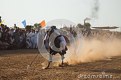 Horse rider, riding in a tent pegging event Editorial Stock Photo