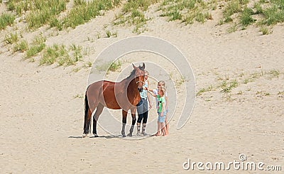 Horse with rider and two girls on the North Sea Texel beach Editorial Stock Photo