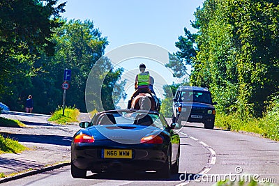 Horse riders and cars Battery Hill road East Sussex England Editorial Stock Photo