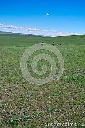 Horseback riders in grassland Stock Photo