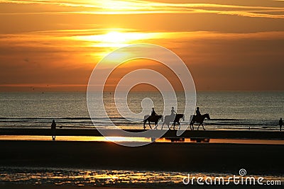 Horseriding in the sunset Stock Photo