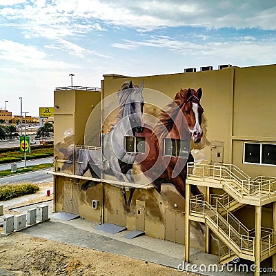 Horses running in a mural of street art in Abu Dhabi in the UAE Editorial Stock Photo