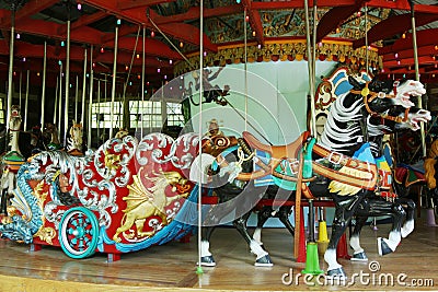 Horses on a traditional fairground carousel Editorial Stock Photo