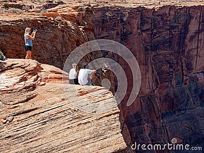 Horseshoe Bend, visitors get too close to the edge of the 1,000 foot deep canyon. Glen Canyon National Recreation Area, Page, Ariz Editorial Stock Photo