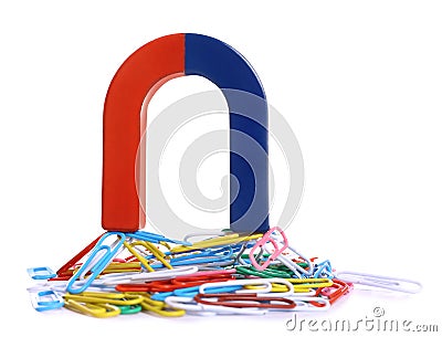 Horseshoe magnet attracting paper clips on background Stock Photo