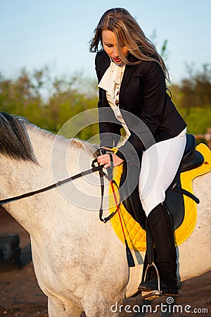 Horsewoman at hippodrome and blue sky Stock Photo