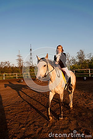 Horsewoman at hippodrome and blue sky Stock Photo