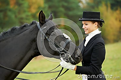 Horsewoman jockey in uniform with horse Stock Photo