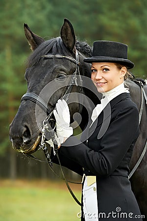 Horsewoman jockey in uniform with horse Stock Photo