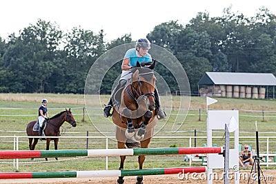 Horsewoman during the jump-off Editorial Stock Photo