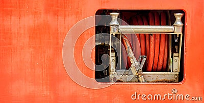 Hoses to quench the fire and fire rolling extinguisher in fire truck Stock Photo