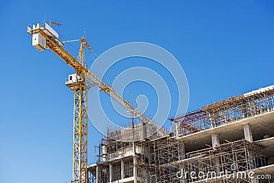 Hospital building under construction with cranes against a blue sky. Stock Photo