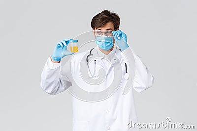 Hospital, healthcare workers, covid-19 treatment concept. Lab technician, doctor examine urine sample in laboratory Stock Photo