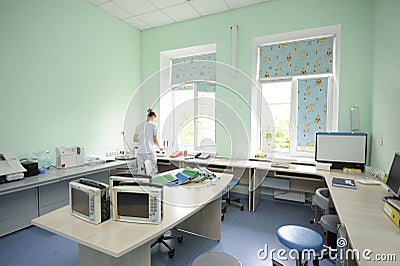 At a hospital laboratory. Lab technician performing analysis of blood samples with gas-electrolyte analyzer Editorial Stock Photo