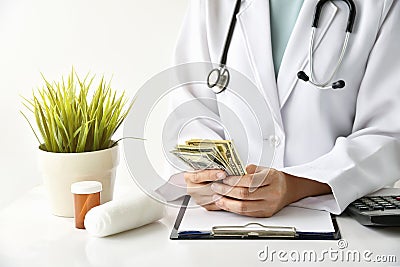 Hospital and medical expense, Doctor holding banknote money. Stock Photo
