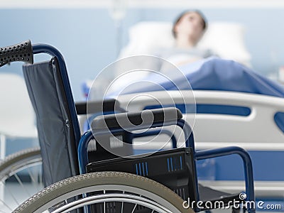 Hospitalized patient lying in bed and wheelchair Stock Photo