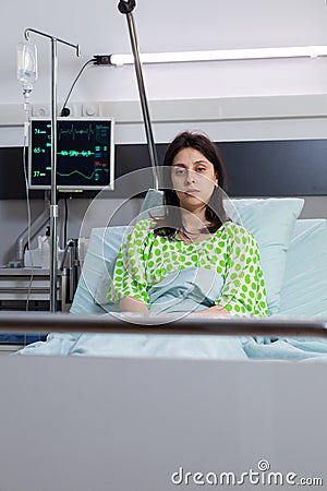 Hospitalized sick woman with nasal oxygen tube looking into camera Stock Photo