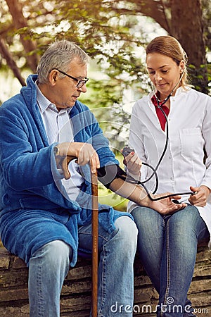 Hospitals, Labs and Clinics- assessment of blood pressure elderly man. Stock Photo