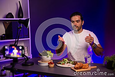 Host channel presenting fresh vegetables in special dish. Surmise. Stock Photo